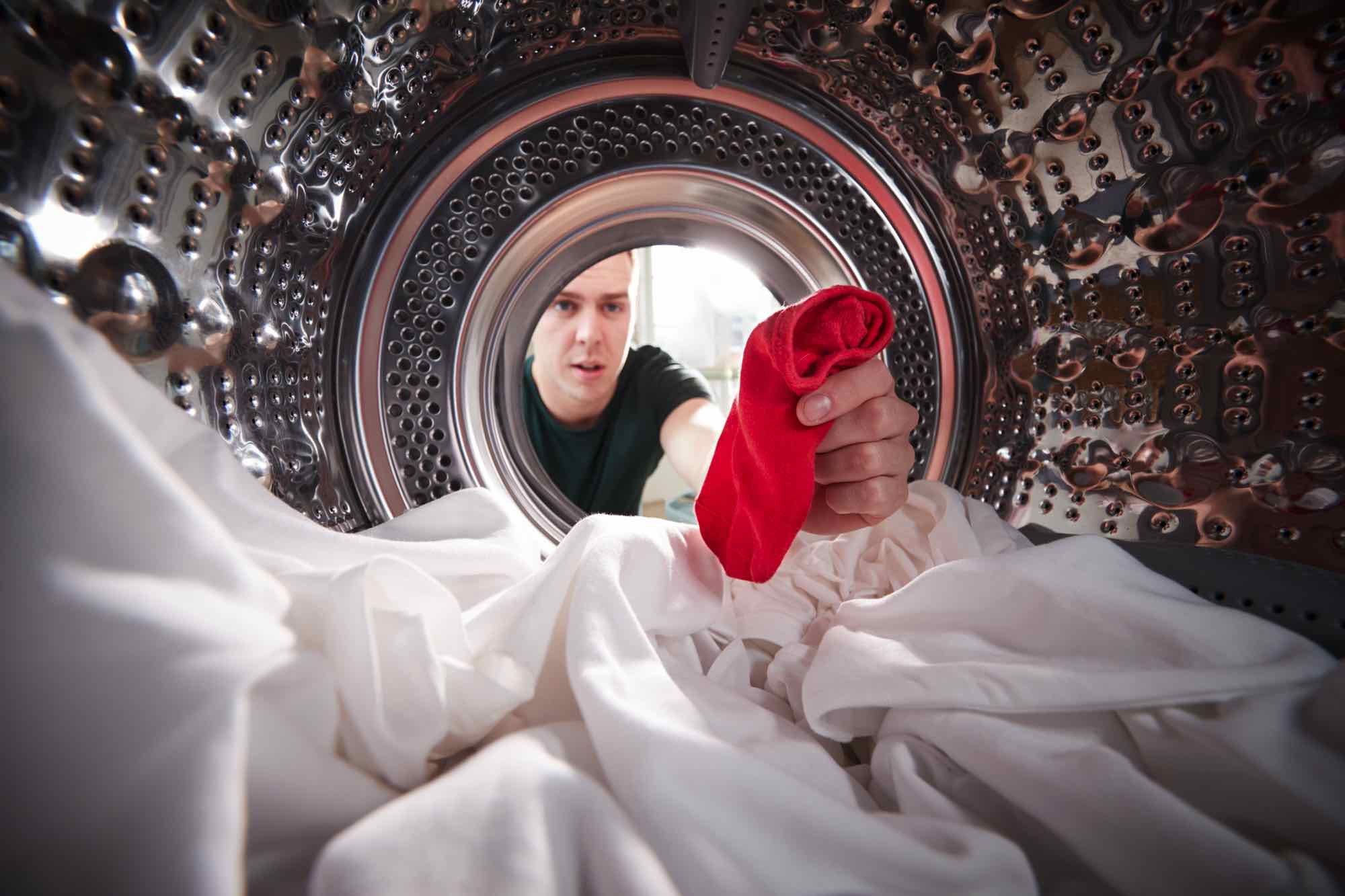 man-taking-out-red-sock-mixed-with-white-laundry-f-9QCYZ5S.jpg